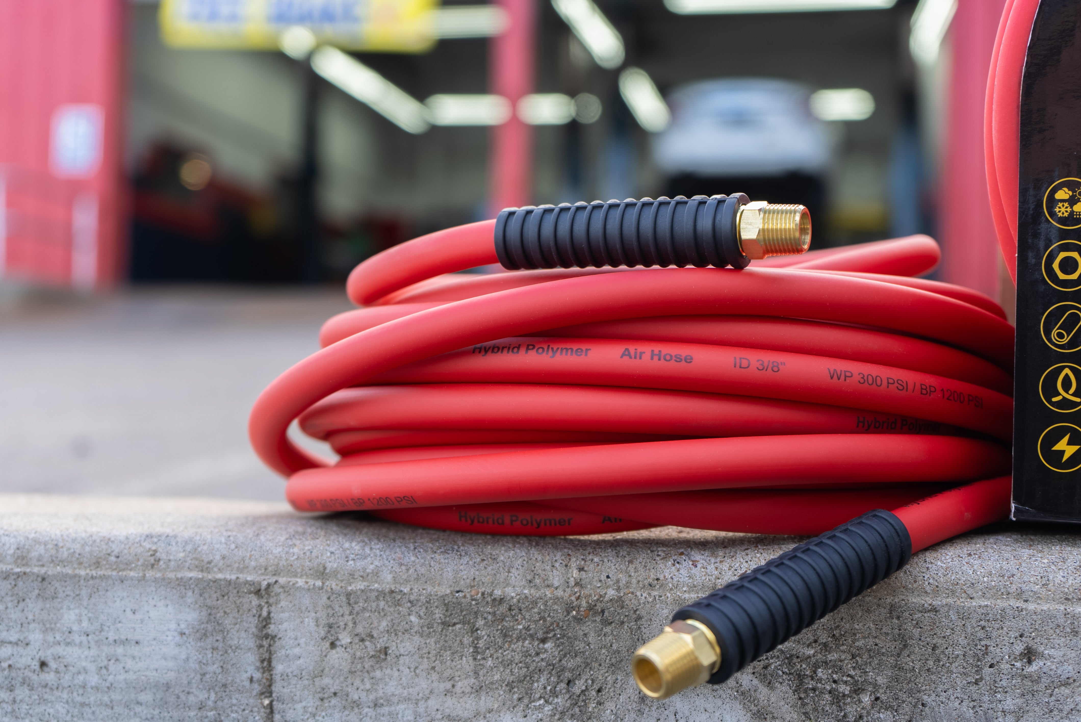 closeup of Flexon Hybrid Air Hose in front of tire shop